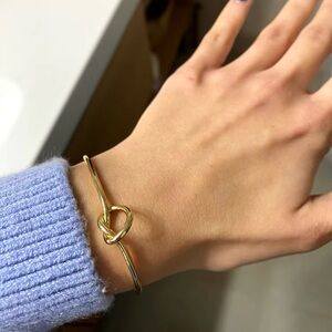 Gold and silver bracelet with a knot design